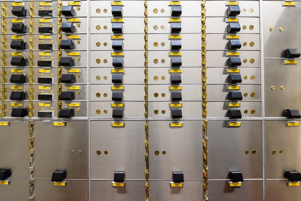 Close-up of a safe deposit box nest with numbered yellow tags and lever locks