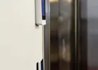Show photo 10: Paznic screen and reader mounted on the wall beside the polished vault door