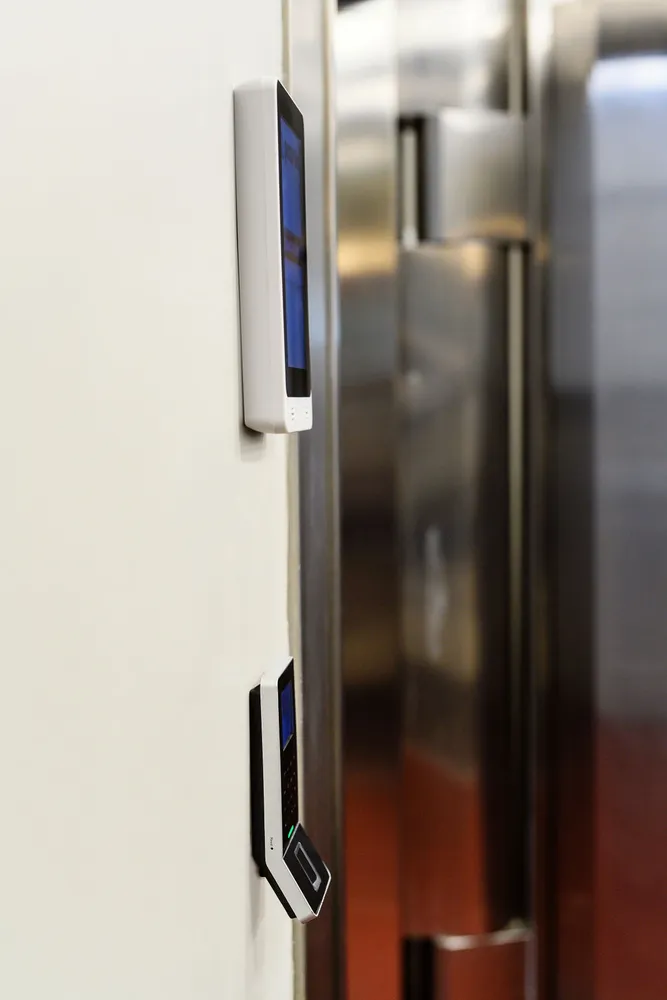 Paznic screen and reader mounted on the wall beside the polished vault door