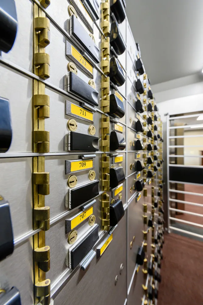 Wall of safe deposit boxes with one box door standing open