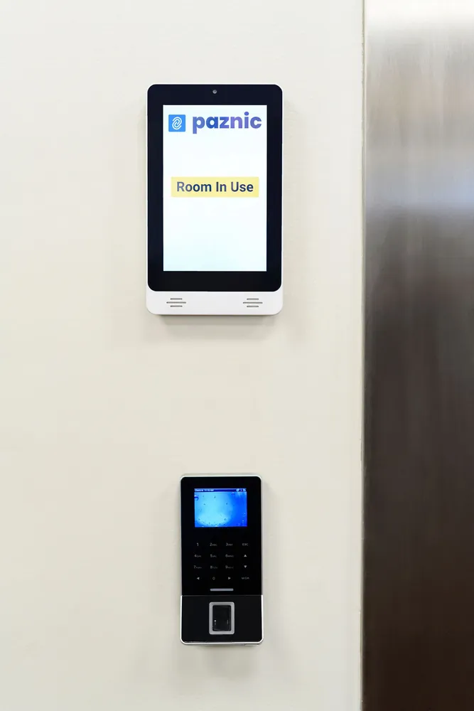 Paznic touch screen showing Room In Use above the fingerprint reader